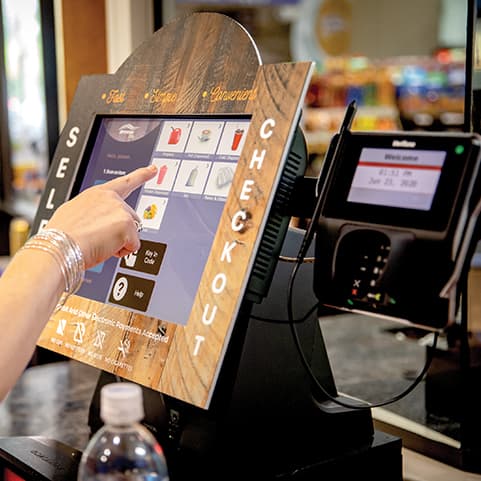 Person using a self-service checkout terminal